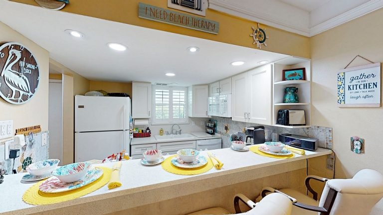 Fully equipped kitchen with breakfast bar seating at Ocean Club South vacation condo