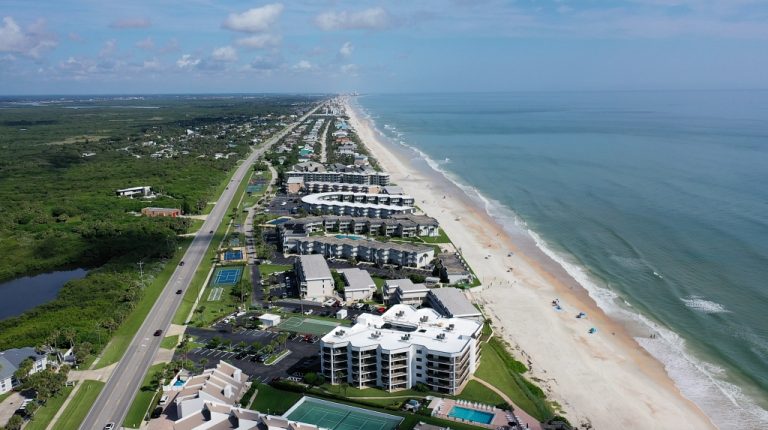 Aerial view of the New Smyrna Beach coastline and Ocean Club South oceanfront community